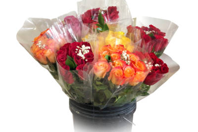 Eight red, pink, orange, and yellow dozen-rose bouquets sprinkled with little white flowers in a black container.